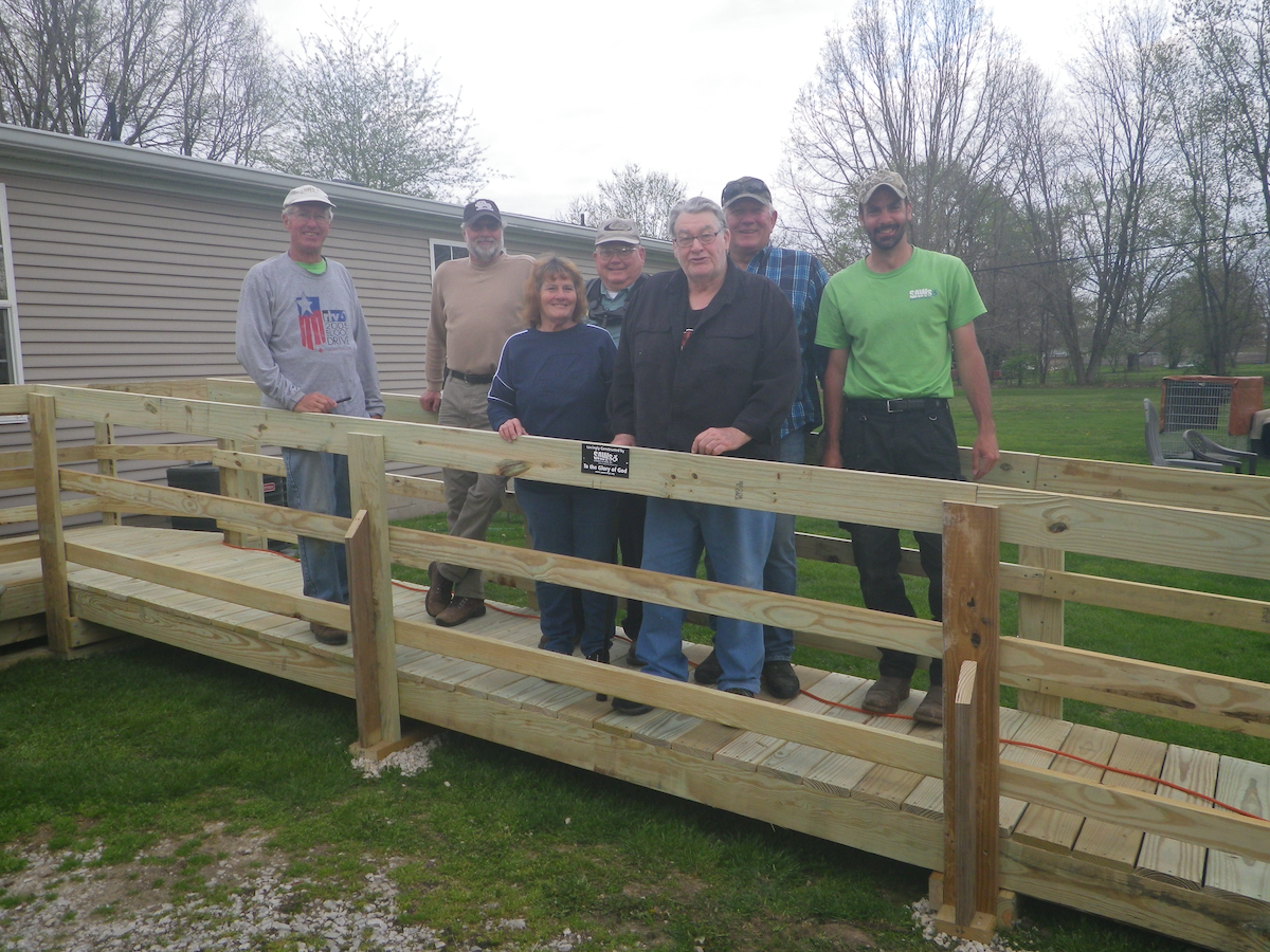 PM Alan and crew with clients on a new wooden access ramp in front of a home