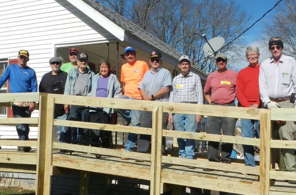 Volunteers pose with Floyd and Nancy on their new ramp.