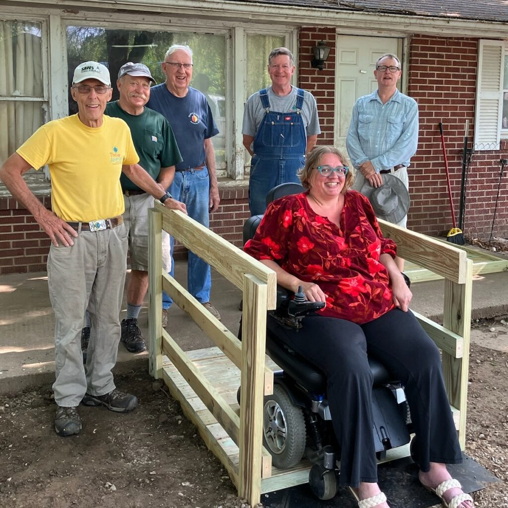 Trish in Bartholomew County and SAWs volunteers on her new ramp, built to fit a motorized chair.